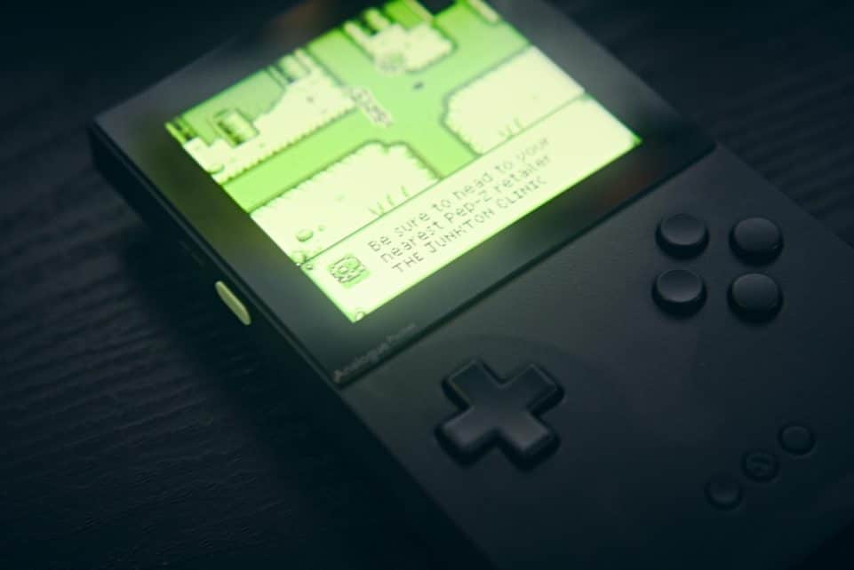 A handheld console displays a map on its screen.