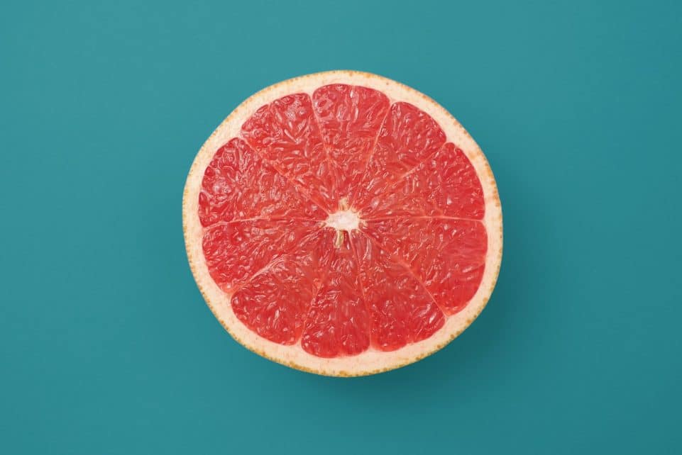 sliced orange fruit on blue background