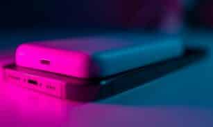 a couple of cell phones sitting on top of a table