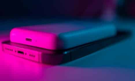 a couple of cell phones sitting on top of a table