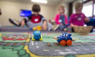 a group of children playing with toys on the floor