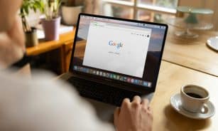 person using macbook pro on table