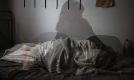 shadow of woman on bed
