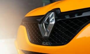 a close up of the front grill of a yellow sports car