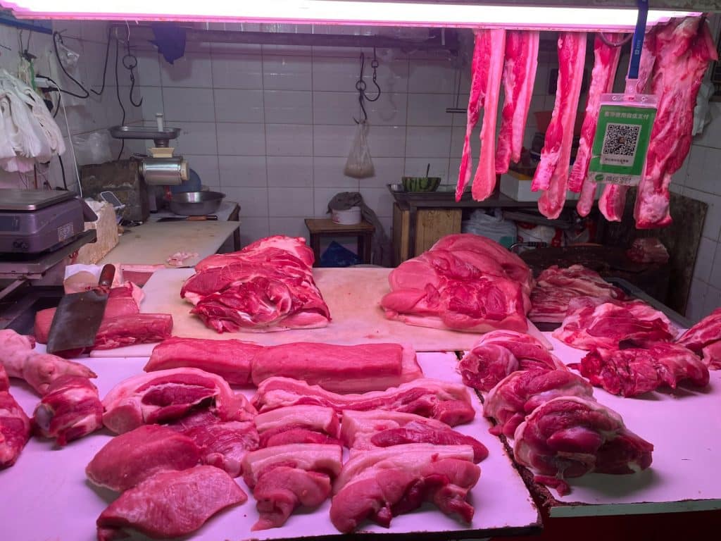 Various cuts of raw meat displayed at a butcher shop.