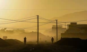 silhouette of person standing on hill during daytime