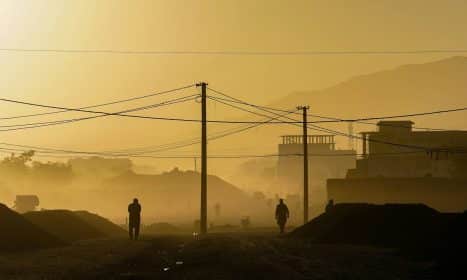 silhouette of person standing on hill during daytime