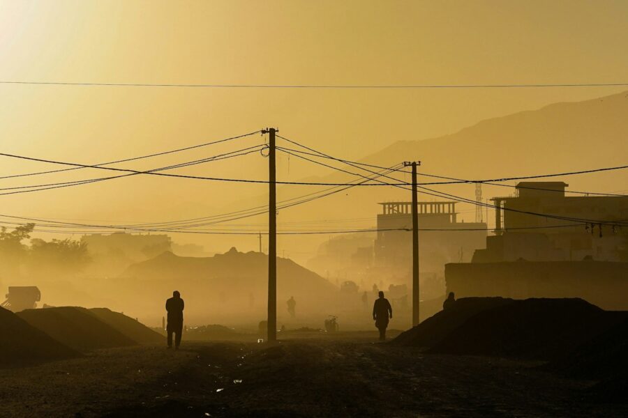 silhouette of person standing on hill during daytime