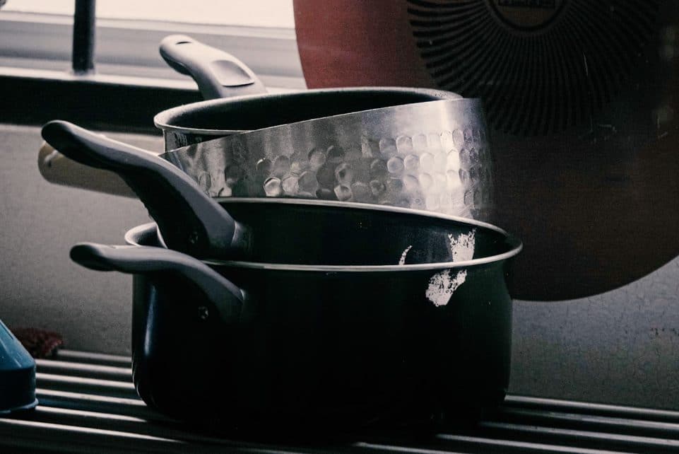 Stack of pots and pans on a drying rack.