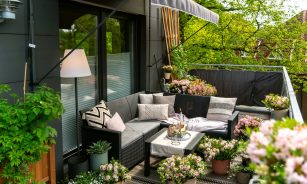 A cozy and decorated balcony with plants.