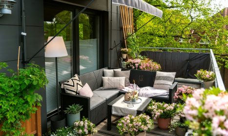 A cozy and decorated balcony with plants.
