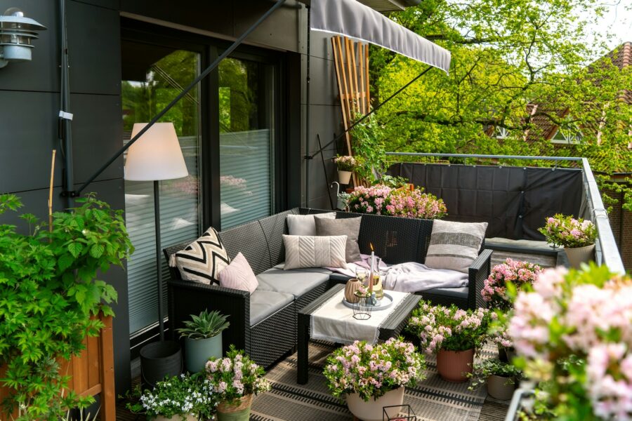 A cozy and decorated balcony with plants.
