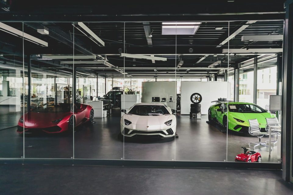 three white, red, and green Lamborghini coupes