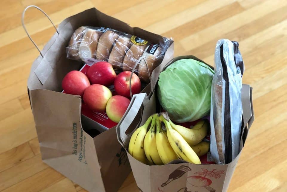 apples and bananas in brown cardboard box