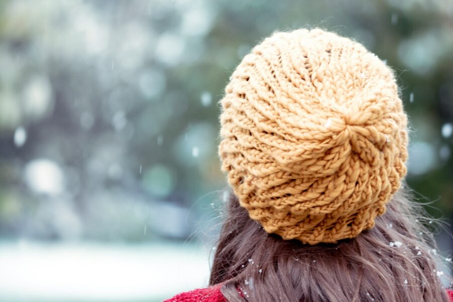 woman in brown knit cap and red shirt