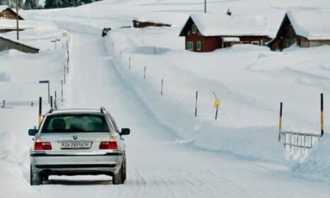 a car driving down a snow covered road