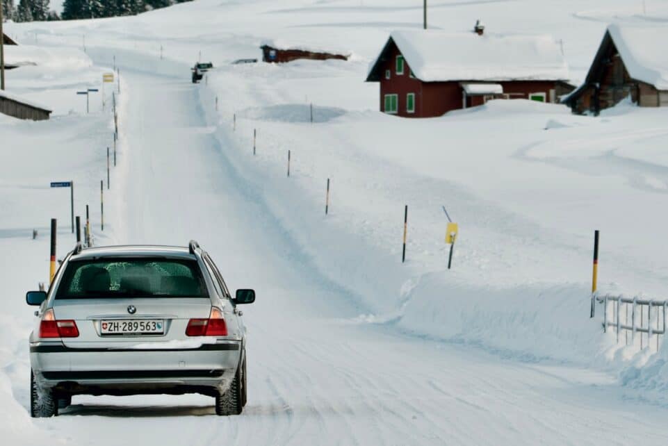 a car driving down a snow covered road