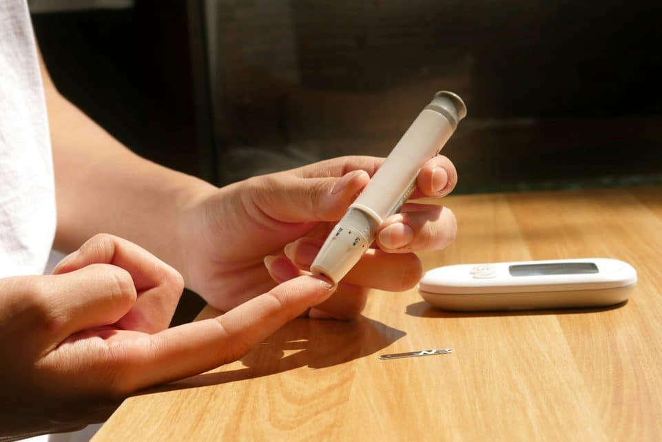 a person sitting at a table with a cell phone