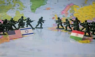 Toy soldiers face off on world map with flags.
