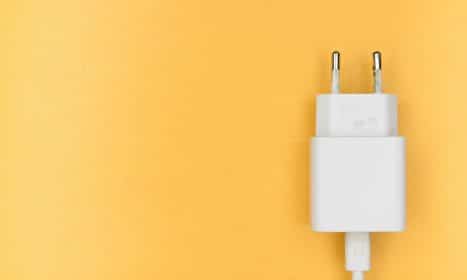 white adapter on yellow wall