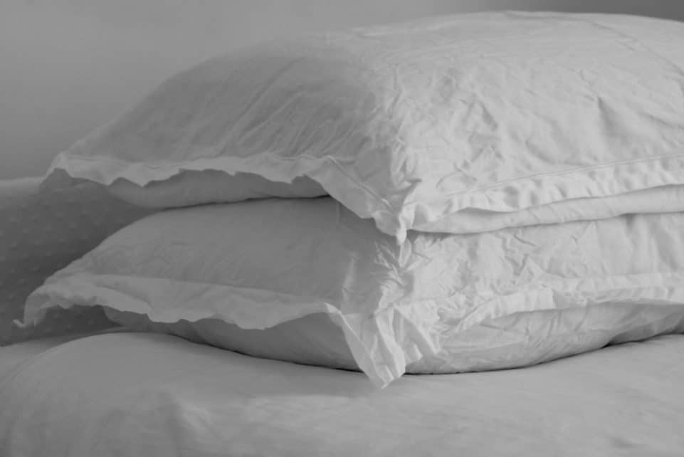 white bed pillow on bed
