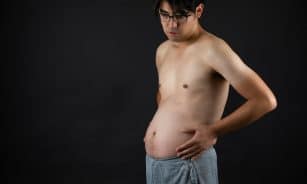 topless man in blue denim jeans