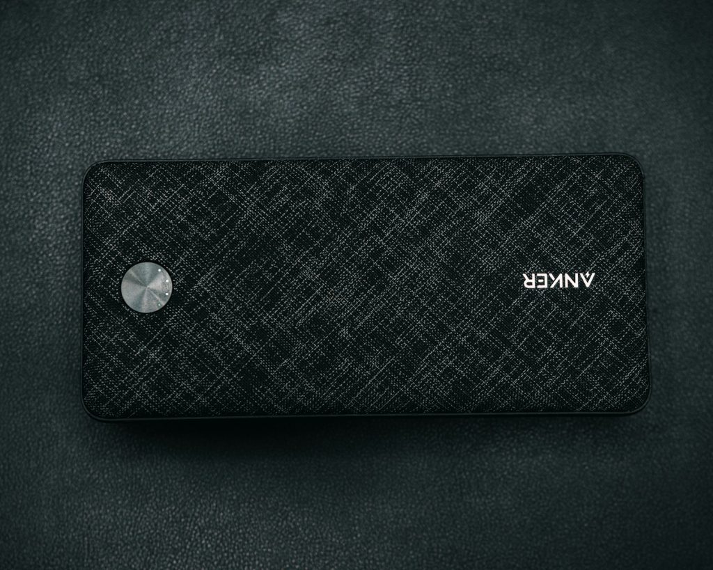 a black speaker sitting on top of a black table