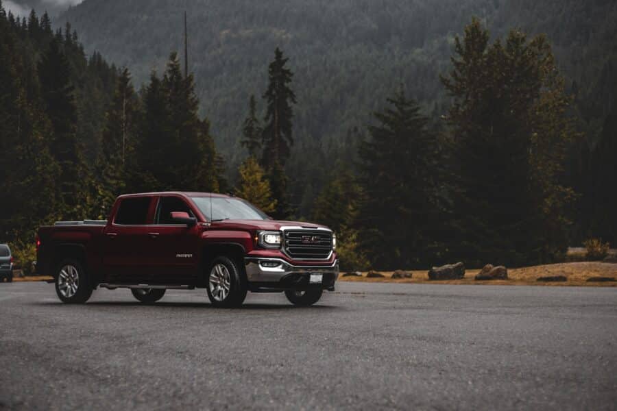 red chevrolet crew cab pickup truck on road during daytime