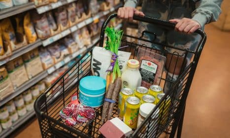 a person pushing a shopping cart full of food