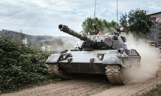 battle tank on green grass field during daytime