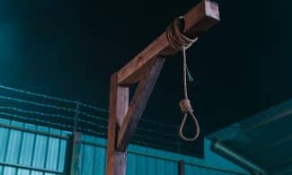 a rope tied to a wooden post in front of a building