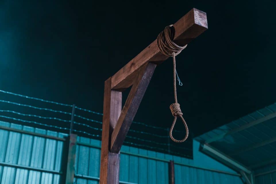 a rope tied to a wooden post in front of a building