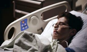 man in blue hoodie wearing eyeglasses