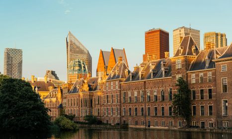 A large building with a lot of windows next to a body of water