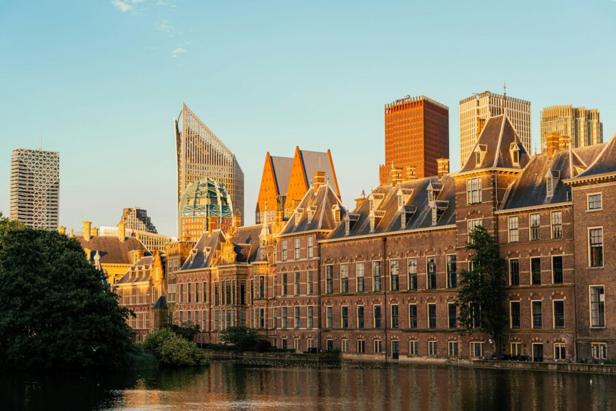 A large building with a lot of windows next to a body of water