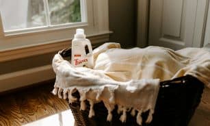 a bottle of deodorant sitting on top of a blanket