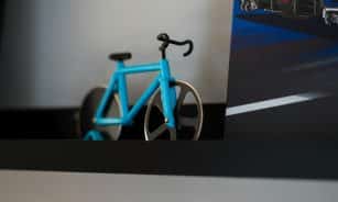 a blue bike sitting on top of a shelf