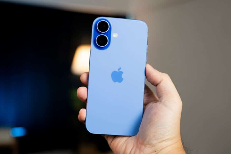 A person holding a blue iPhone in their hand