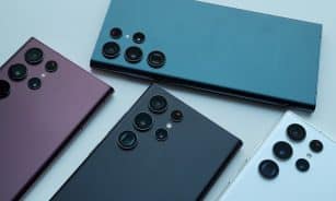 a group of four different colored cell phones