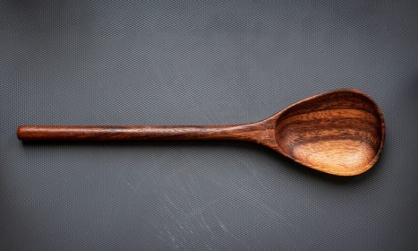 brown wooden spoon on white surface