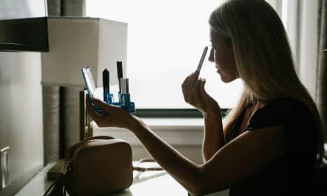 woman in black tank top holding pen