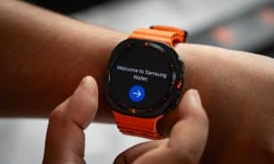 A close up of a person holding a smart watch