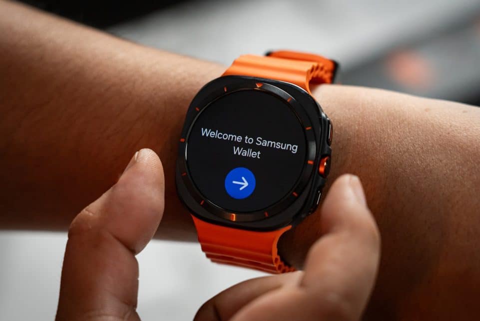 A close up of a person holding a smart watch