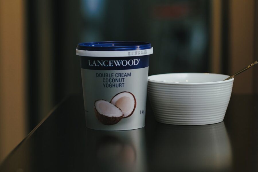 a cup of coffee next to a container of ice cream
