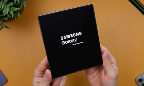 A person holding a black box with the samsung logo on it