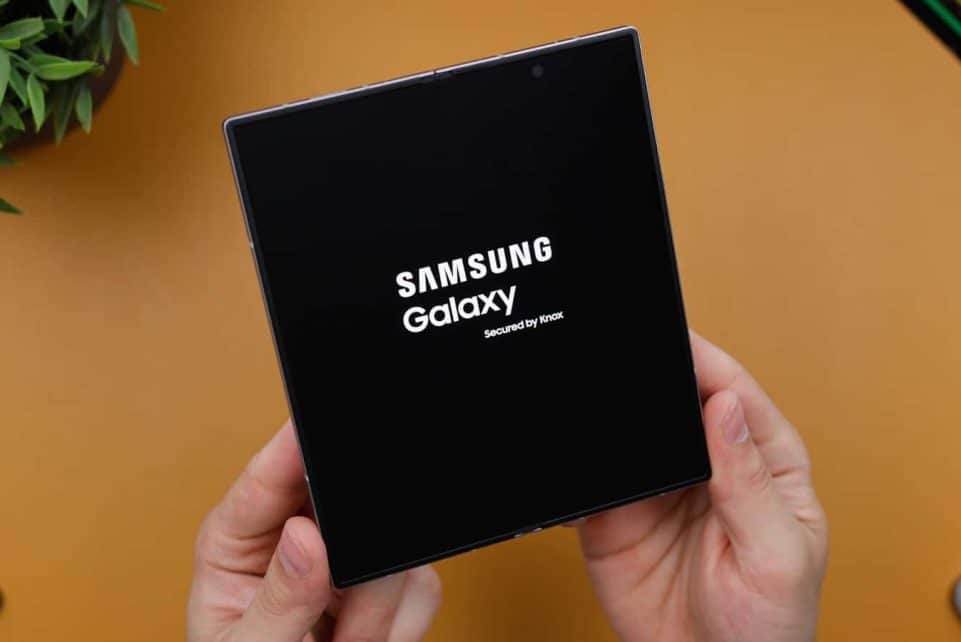 A person holding a black box with the samsung logo on it