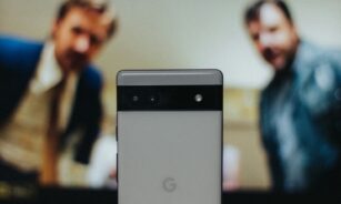 a close up of a cell phone near a television