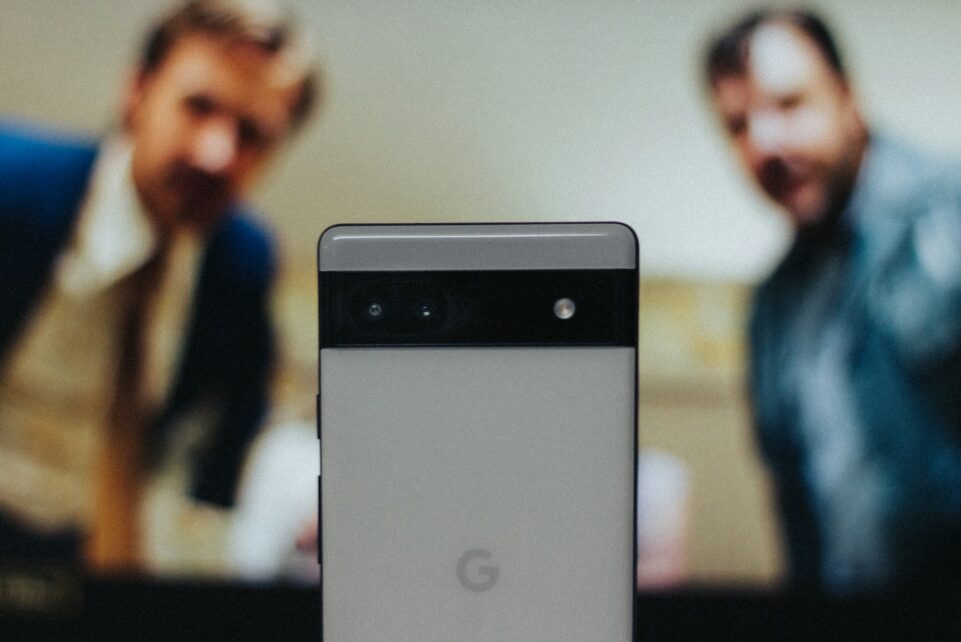 a close up of a cell phone near a television