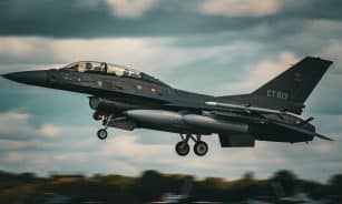 a fighter jet flying through a cloudy sky