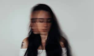 a blurry photo of a woman with glasses